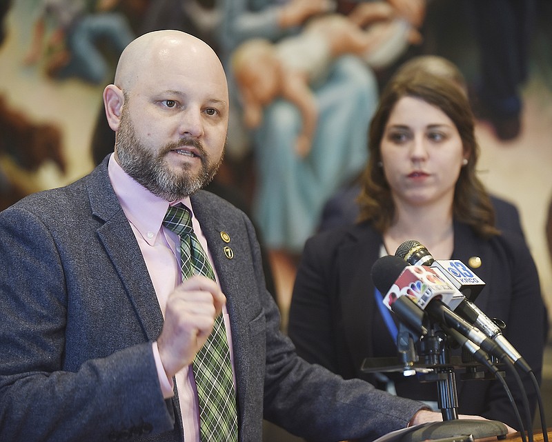 Crystal Quade, D-Springfield, at right, listens as Mark Ellebracht, D-Liberty, addresses reporters Monday during a news conference in the House of Representatives Lounge. Quade serves as Minority Floor Leader and also as member of the Democratic Caucus.