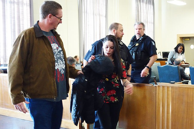 Shaina Osborne, center, leaves the Callaway County courtroom after pleading guilty to making a false report of a missing person. She and Anthony R.K. Osborne became the first defendants sentenced in the Carl DeBrodie case on Monday.