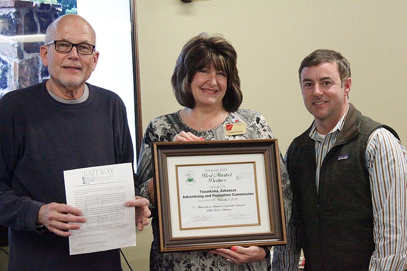 Tom Ayers, chairman of the Gateway Farmers Market Oversight Committee, presents Linda Teeters and Brandon Cogburn of the Texarkana, Ark., Advertising and Promotion Commission a plaque from the Arkansas Farmers Market Association,  recognizing the commission's efforts to help improve Gateway Farmers Market's facilities for both vendors and customers. The recognition took place Tuesday night at Northside Church in Texarkana, Texas.
