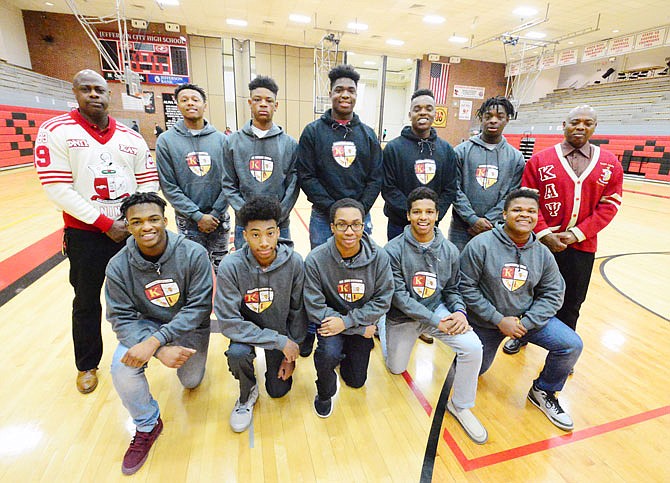 Marvin Pettaway, far left, President of the JC Alumni Chapter of Kappa Alpha Psi, and Carl Dement, far right, chairman and advisor, stand Friday with Jefferson City High School students and Kappa League members.