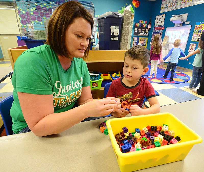 Mark Wilson/News Tribune
Christa Luebbering and son Beau, 5, at Courtyard Early Learning Center, make dinosaurs. Courtyard Early Learning Center is expanding to a second location to be built on Oscar Drive.