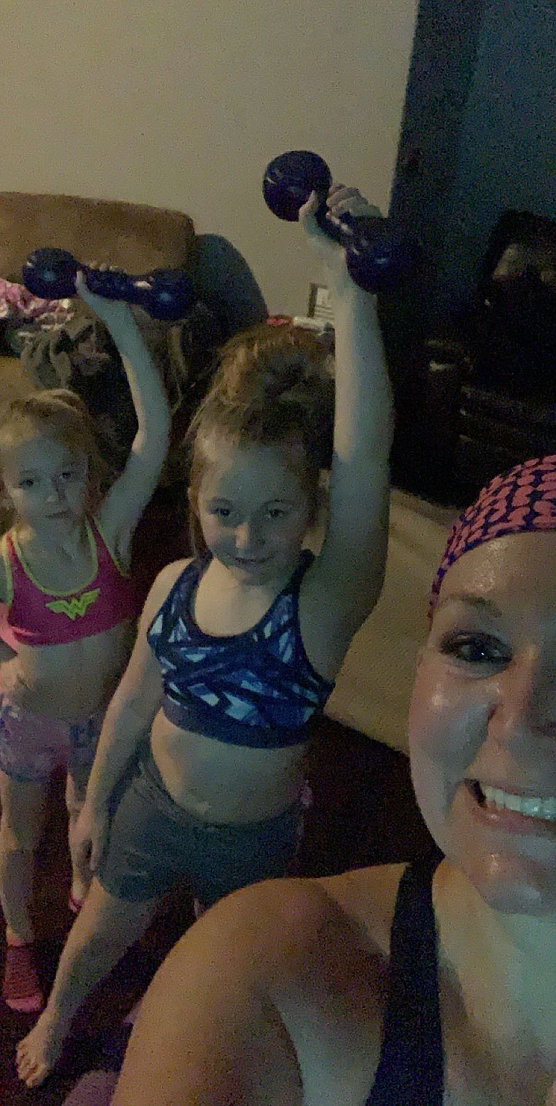 <p>(Courtesy of Crystal Tellman) Crystal Tellman takes a selfie with her daughters as they work out at home.</p>