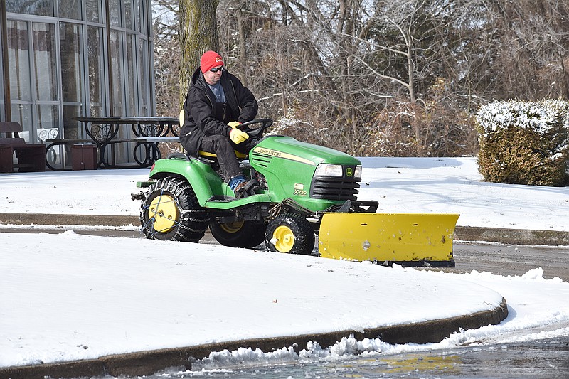 Tom Janson of the Jefferson City YMCA clears snow Sunday from the Community Christian Church lot. The church is beside the Firley YMCA, which contracts with the church to share its lot. 