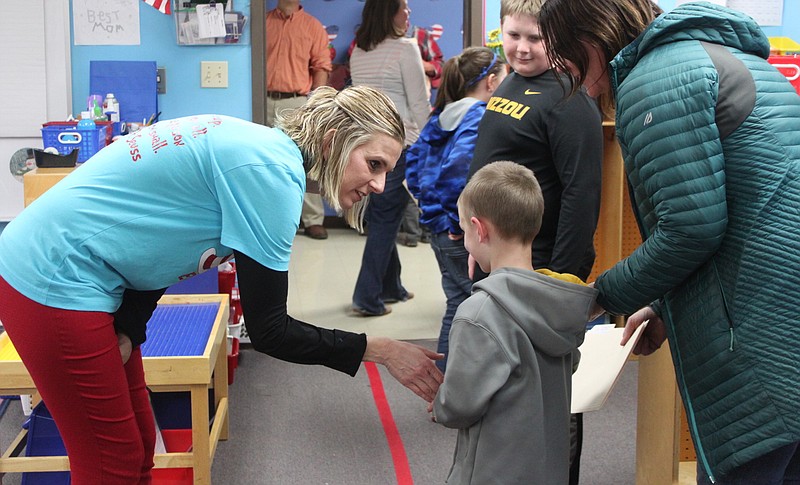 <p>Democrat photo/Liz Morales</p><p>Sarah Russell, a kindergarten teacher at California Elementary School, takes time to greet one of her possible future students at Kindergarten Information Night.</p>