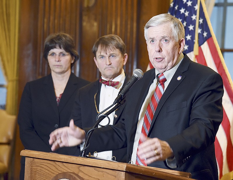 Gov. Mike Parson held a press conference Monday in his Capitol office to announce the new Child Care working group, a collaborative effort designed to ensure safe and quality care for Missouri children. Standing in the background are Department of Public Safety Director Sandra Karsten and Dr. Randall Williams, director of Department of Health and Senior Services. The news conference was in response to an incident at a St. Louis day care where a child was seen on video being thrown by a day care employee.