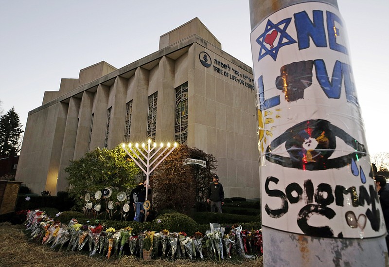 FILE - In this Dec. 2, 2018 photo, a menorah is tested outside the Tree of Life Synagogue in preparation for a celebration service at sundown on the first night of Hanukkah, in the Squirrel Hill neighborhood of Pittsburgh. A $6.3 million fund established in the wake of the Pittsburgh synagogue massacre will primarily be split among the families of the dead and survivors of the worst attack on Jews in U.S. history. The Jewish Federation of Greater Pittsburgh made the announcement Tuesday, March 5, 2019. (AP Photo/Gene J. Puskar, File)