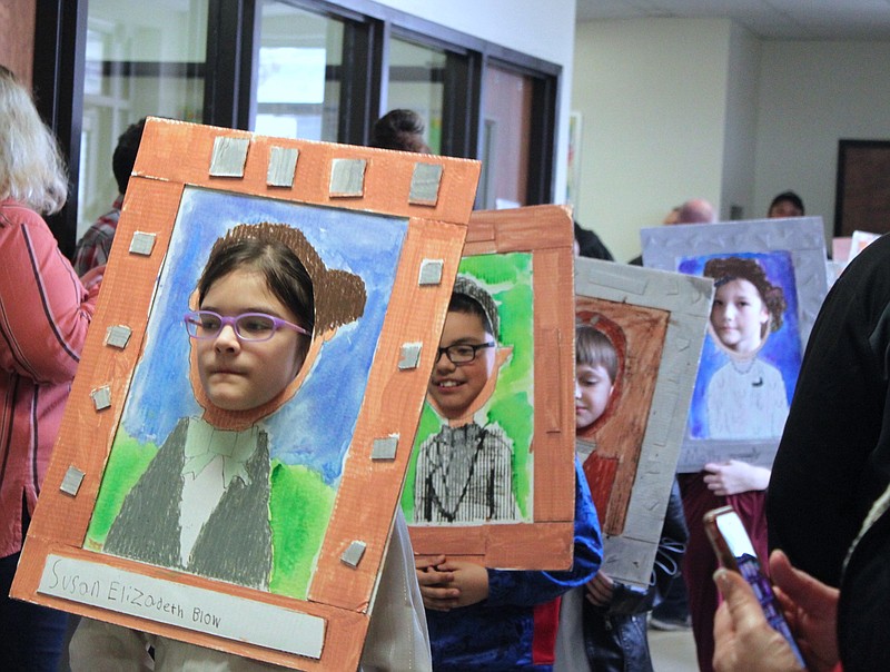 Susan Elizabeth Blow, who started the first kindergarten class in the United States, leads a parade of Famous Missourians on March 1 down the halls of California Elementary School. Blow and her famous peers were portrayed by CES third-grade students.