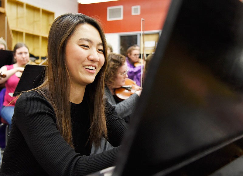 Pianist Eunhyang Koh laughs while rehearsing with the Jefferson City Symphony Orchestra in preparation for their final performance at Jefferson City High School. Koh won the orchestra's pianist competition, and came to Jefferson City from Springfield, Mo., to attend the rehearsal.