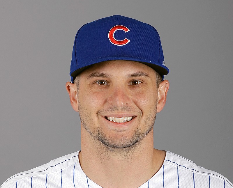 This is a 2019 photo showing Kendall Graveman of the Chicago Cubs baseball team. Graveman is surrounded by new faces while he travels a tedious road back to the majors. Graveman signed a one-year contract with the Chicago Cubs in December after his 2018 season with Oakland was cut short by reconstructive elbow surgery. It's a chance to use major league facilities to rehab a major injury under the care of a top-notch medical staff, but it's also a potentially awkward situation trying to get to know a new group of teammates without taking the field with them right away. (AP Photo/Darron Cummings, File)