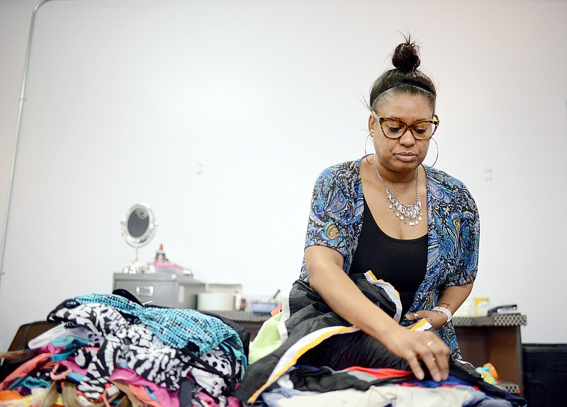 Sally Ince/ News Tribune
Owner Tina Cole organizes a pile of clothing Friday March 8, 2019 at The Xchange Boutique. Cole is in the process of selling the boutique to focus more on her growing family and plans to close by early Summer. She also plans to host a variety of sales before closing and will be announcing the sale on The Xchange boutique Facebook page.    