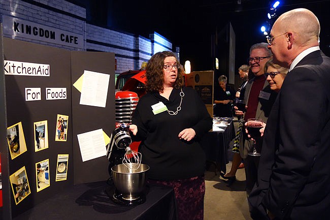 Amy Lee, left, a teacher at Futon High School, tells Fulton Public School Foundation Gala attendees about how the four KitchenAid mixers awarded to the Foods and Advanced Foods lab have benefited the class. She and other classroom grant recipients attended the 2018 FPSF Gala.
