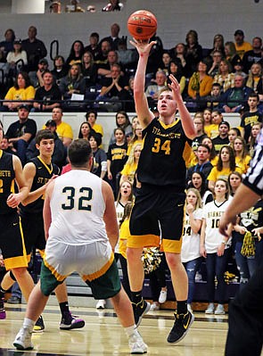 Brady Heckemeyer of St. Elizabeth releases a shot over Ryan Taylor of Lakeland during last Saturday's Class 1 quarterfinal at Meyer Sports Center in Bolivar.