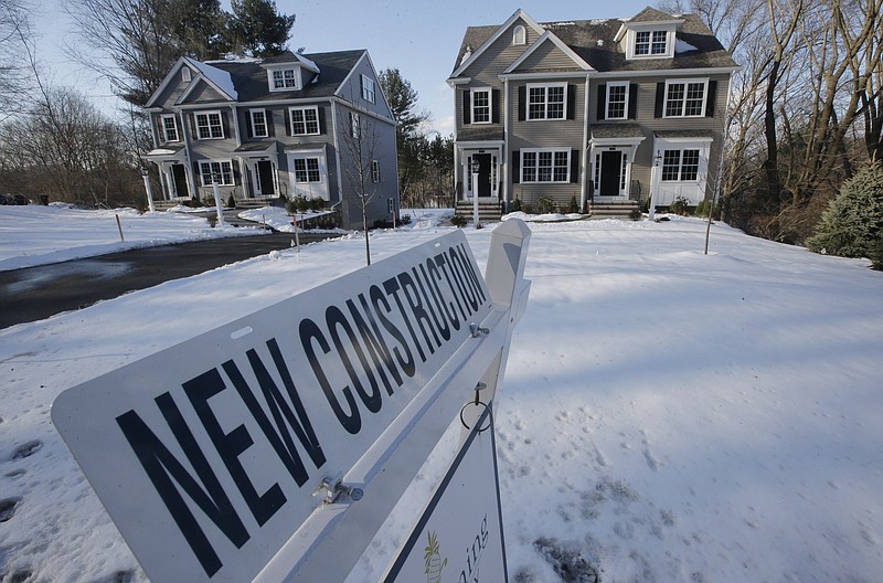 In this Thursday, Feb. 21, 2019 photo a newly constructed homes sit near a sign, in Natick, Mass. On Friday, March 8, the Commerce Department reports on U.S. home construction in January.(AP Photo/Steven Senne)