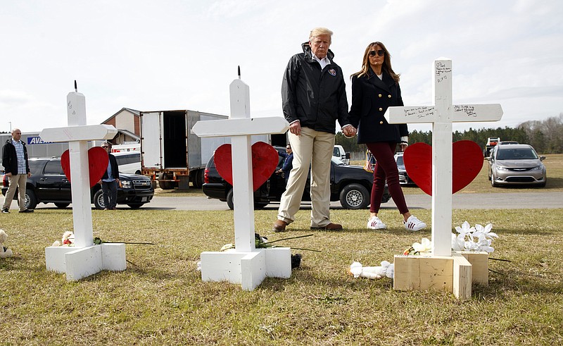 President Donald Trump and first lady Melania Trump visit crosses at Providence Baptist Church in Smiths Station, Ala., Friday, March 8, 2019, as they travel to tour areas where tornados killed 23 people in Lee County, Ala. (AP Photo/Carolyn Kaster)
