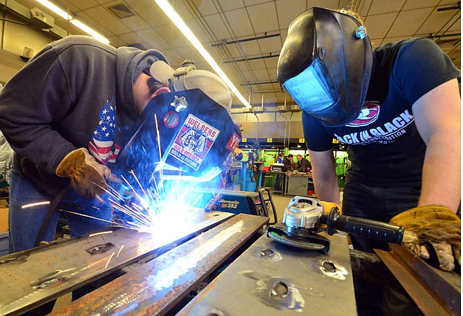 Jefferson City High School seniors Max Hughes, left, and Isaac Stegeman work on a plug welding project Friday at the Nichols Career Center.