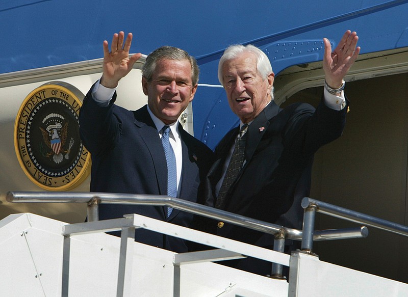  In this March 8, 2004, file photo, then President Bush, left, waves with Rep. Ralph Hall, R-Texas, right, as they step off Air Force One upon Bush's arrival in Dallas. Former Rep. Hall, the oldest-ever member of the U.S. House, has died at age 95. (AP Photo/Charles Dharapak, File)