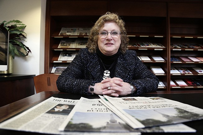 Penelope Muse Abernathy, a University of North Carolina professor, stands with the daily newspaper selection in the Park Library at the School of Journalism in Chapel Hill, N.C., on Thursday, March 7, 2019. "Strong newspapers have been good for democracy, and both educators and informers of a citizenry and its governing officials. They have been problem-solvers," said Abernathy, who studies news industry trends and oversaw the "news desert" report released the previous fall. (AP Photo/Gerry Broome)