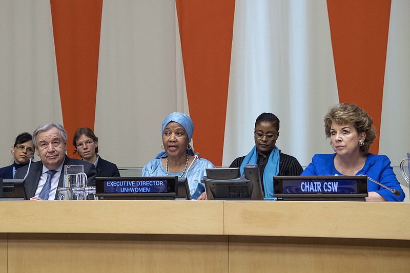 In this Friday, March 8, 2019 photo provided by the United Nations, Phumzile Mlambo-Ngcuka, third from right, executive director of UN Women, speaks at the United Nations Observance of International Women's Day at the United Nations headquarters. Mlambo-Ngcuka is calling for the revolution in technology to be used to benefit the world's poor and especially women who will not achieve gender equality without "the giant leap that 21st century innovations can bring." At left is U.N. secretary General Antonio Guterres, and at right is Geraldine Byrne-Nason, chair of the Commission on the Status of Women and Permanent Representative of Ireland to the United Nations. (Eskinder Debebe/The United Nations via AP)