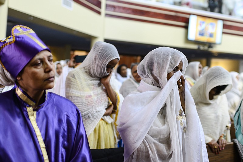 Members of the Ethiopian community take part in a special prayer for the victims of the Ethiopian Airlines flight ET302 crash, at the Ethiopian Orthodox Tewahedo Church of Canada Saint Mary Cathedral in Toronto, on Sunday, March 10, 2019. Ethiopian Airlines flight ET302 crashed shortly after takeoff from Ethiopia's capital on Sunday morning, killing all 157 on board, authorities said, including 18 Canadians. (Christopher Katsarov/The Canadian Press via AP)