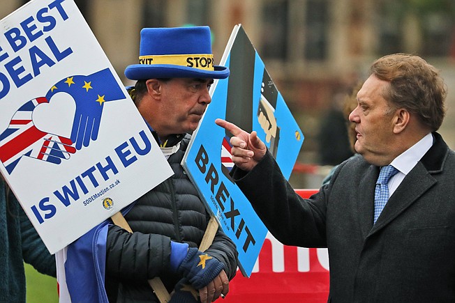 Protestors react as they demonstrate in front of the Houses of Parliament in London, Wednesday, March 6, 2019. Britain's chief law officer said Wednesday that Brexit negotiations with the European Union had got to "the meat of the matter," after Northern Ireland's top civil servant warned that a disorderly U.K. exit could destabilize both the economy and the peace process. (AP Photo/Frank Augstein)