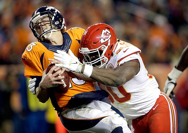 In this Nov. 27, 2016, file photo, Chiefs outside linebacker Justin Houston sacks Broncos quarterback Trevor Siemian in the end zone for a safety during the first half of a game in Denver. 