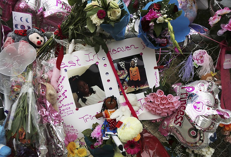 Dozens of tributes are seen at a large memorial to Trinity Love Jones, the 9-year-old girl whose body was found in a duffel bag along a suburban Los Angeles equestrian trail, in Hacienda Heights, Calif., Monday, March 11, 2019. Two people have been detained in connection with the case. The discovery happened last week. (AP Photo/Reed Saxon)