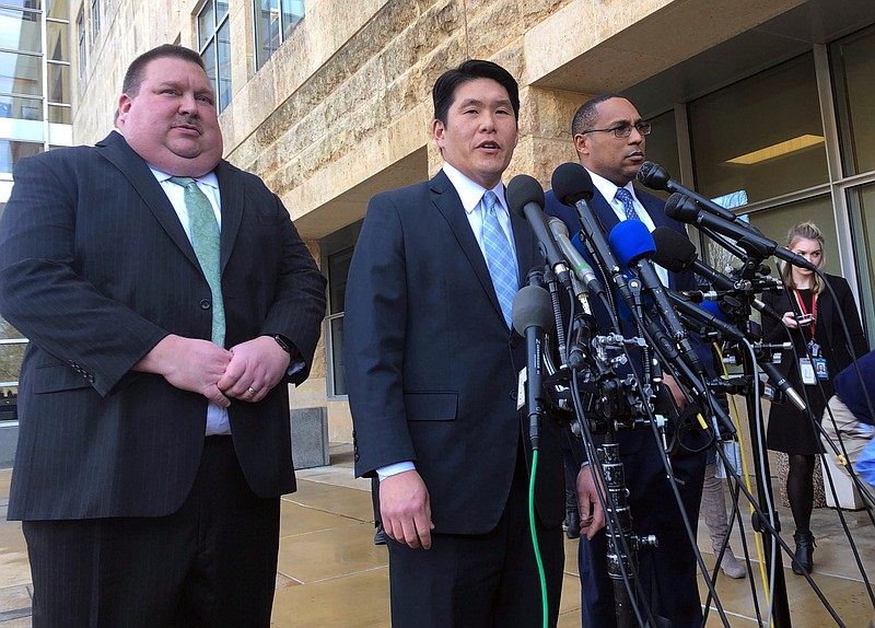 File-This Feb. 21, 2019, file photo shows U.S. Attorney Robert Hur, center, of the District of Maryland, speaks as Art Walker, left, special agent from the Coast Guard investigative service, and Gordon Johnson, special agent in charge of the FBI's Baltimore office, listen during a news conference about Coast Guard Lt. Christopher Paul Hasson, outside the federal courthouse in Greenbelt. Hasson,  accused of stockpiling guns and compiling a hit list of prominent Democrats and network TV journalists pleaded not guilty on Monday, March 11, 2019, to drug and firearms charges. An attorney for Hasson, 49, entered the plea on his behalf at an arraignment on charges of illegal possession of firearm silencers, possession of firearms by a drug addict and unlawful user, and possession of a controlled substance. (AP Photo/Michael Kunzelman, File)