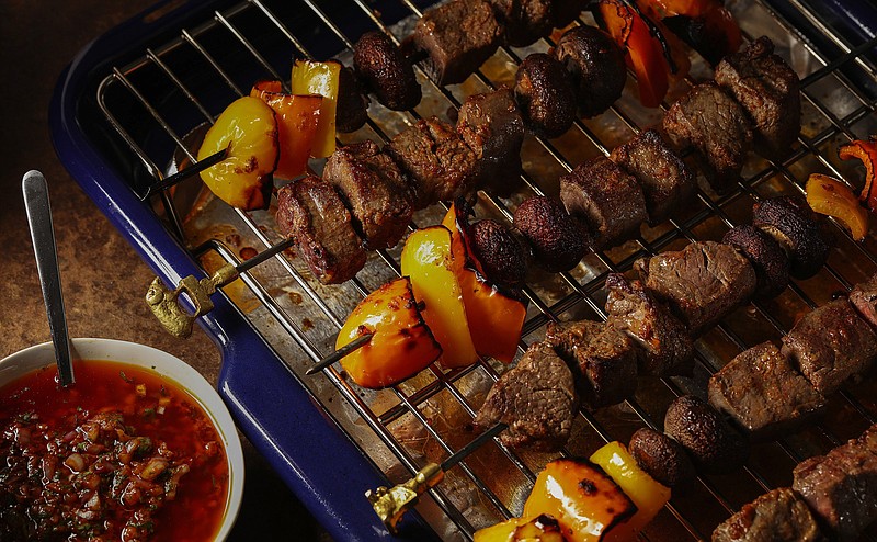 Chunks of beef alternate with bell peppers and baby bella mushrooms for kebabs coated with a spicy red chimichurri sauce. (Abel Uribe/Chicago Tribune/TNS)