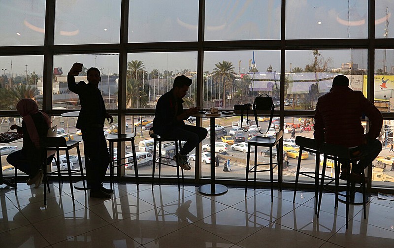 In this Feb. 10, 2019 photo, people eat in a restaurant at a shopping mall in Baghdad, Iraq. For the first time in years, Iraq is not at war. The defeat of the Islamic State group in late 2017 after a ruinous four-year conflict has given the population a moment of respite, and across the capital Baghdad there is a guarded sense of hope.