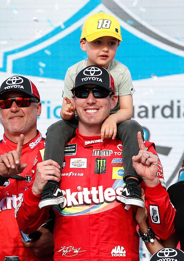 Kyle Busch and his son Brexton celebrate in victory lane Sunday after winning the NASCAR Cup Series race at ISM Raceway in Avondale, Ariz.