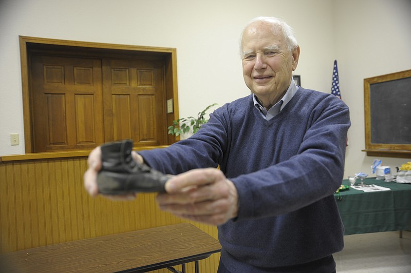 <p>Danisha Hogue/Democrat photo</p><p>Gail Hughes shows a 152-year-old shoe at show and tell during the Moniteau County Historical Society meeting.</p>