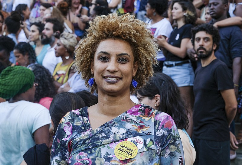 FILE - In this Jan. 9, 2018 file photo, Rio de Janeiro Councilwoman Marielle Franco smiles for a photo in Cinelandia square. Police in Brazil said on Tuesday, March 12, 2019, that they have arrested two suspects in the killing of Franco and her driver last year. (AP Photo/Ellis Rua, File)