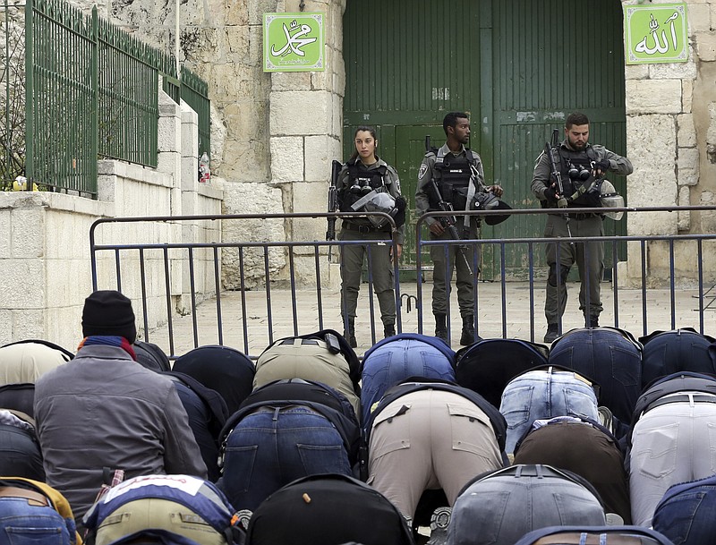 Palestinians pray outside the Old City as Israeli border police blocked the entrances to Al-Aqsa compound in Jerusalem Tuesday, March 12, 2019. Israeli police on Tuesday closed the entrances to Jerusalem's most sensitive holy site after Palestinian suspects threw a firebomb at a police station. (AP Photo/Mahmoud Illean)