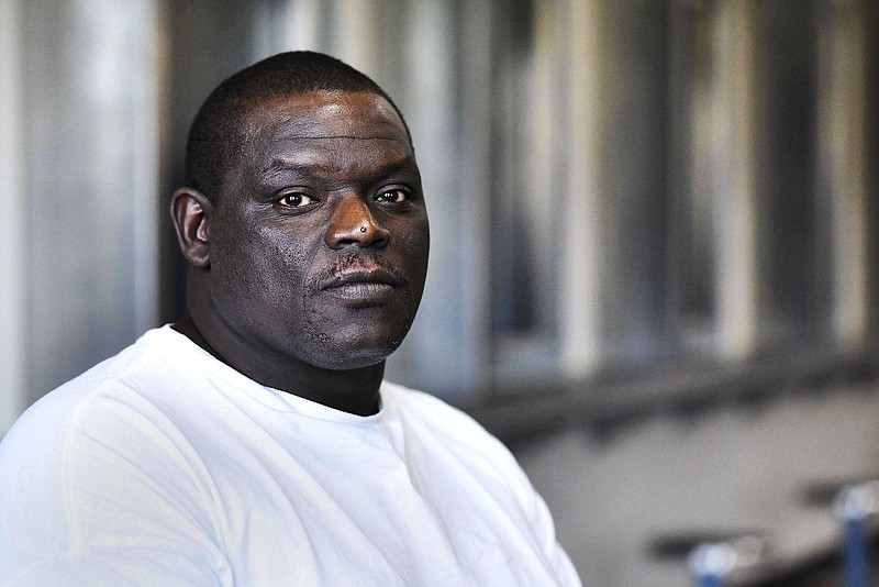 FILE - In this Sept. 2016 file photo, David Robinson poses for a portrait in the visiting area inside Jefferson City Correctional Center in Jefferson City, Mo. Robinson, wrongly imprisoned 17 years for murder alleges in a federal lawsuit that police not only knew he was innocent before his conviction, but helped prevent it from being overturned. The Southeast Missourian reports that attorneys for David Robinson filed the lawsuit Monday, March 11, 2019. (Laura Simon/The Southeast Missourian via AP File)