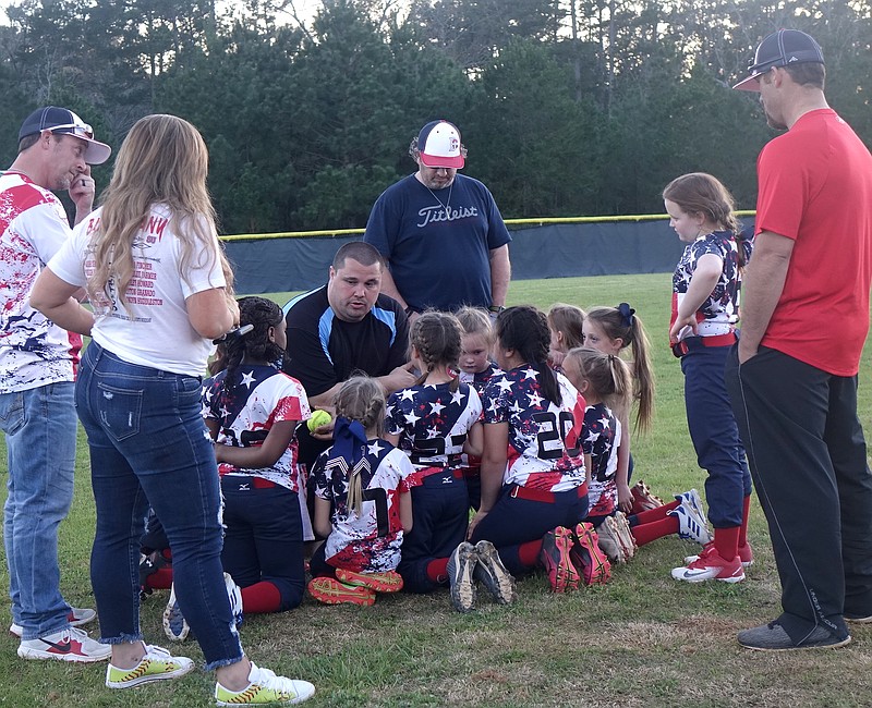 Giving his team last-moment encouragement is Coach Gary Albertson of the Bad Company girls softball team.