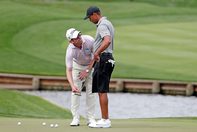Tiger Woods (right) talks with Matt Killen, the putting coach of Justin Thomas, who is working with Woods the week, during a practice round of The Players Championship on Wednesday in Ponte Vedra Beach, Fla.