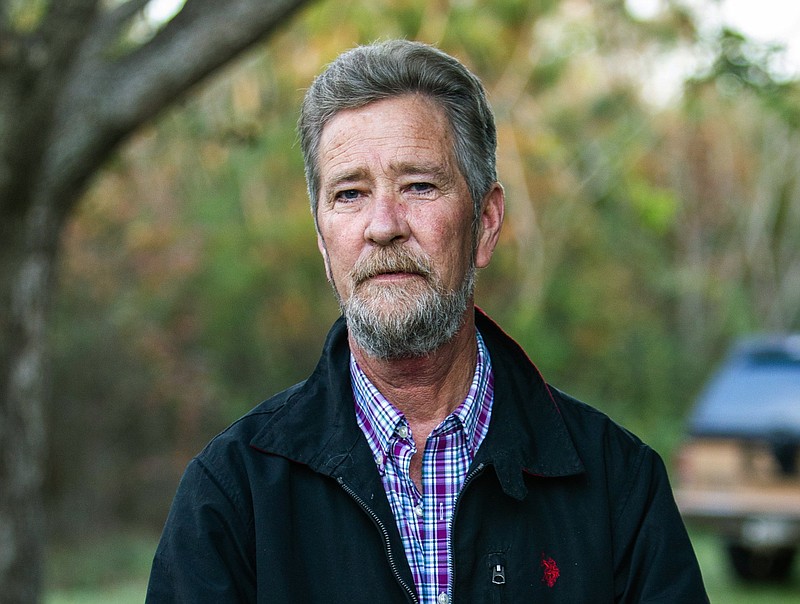 FILE - In this Dec. 5, 2018 file photo, Leslie McCrae Dowless Jr. poses for a portrait outside of his home in Bladenboro, N.C. The North Carolina political operative at the center of a ballot fraud scandal is facing criminal charges for his activities in the 2016 elections and the Republican primary in 2018. Wake County District Attorney Lorrin Freeman said Wednesday, Feb. 27, 2019, that Dowless was arrested after grand jury indictments alleging illegal possession of absentee ballots and obstruction of justice. (Travis Long/The News & Observer via AP, File)
