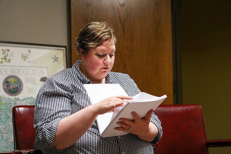 Amanda Bowers sorts through emails and documents from Pleasant Grove Middle School on Tuesday in Texarkana, Texas. Bowers filed a Level 2 grievance with PGISD over her daughter's punishment for lending her school login to a friend, who sent KKK photos to two black students in February of this year.