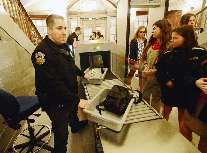 Officers Brian Folker, foreground, and Jeff Lentz of the Capitol Police welcome a group visiting the Missouri state Capitol on Thursday from the School of the Ozarks in Branson.