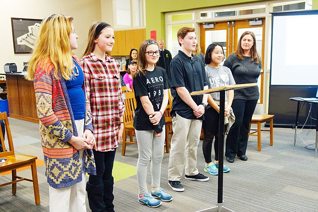 Seventh-graders from Fulton Middle School presented on their "World Changers" projects during Wednesday evening's board of education meeting. Presenting students included Jayla Kemp, left, Ivy Chapla, Kayla Morse, Joe Winterbower and Kelly Zhang. Teacher Melody Hapner, right, is providing guidance for the World Changers projects.