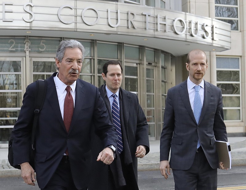 Lawyers for the Chinese electronics giant Huawei from left, James Cole, Michael Alexander Levy, and David Bitkower leave Brooklyn federal court in New York, Thursday March 14, 2019. Lawyers for Huawei have entered a not-guilty plea in a U.S. case charging the company with violating Iran trade sanctions. (AP Photo/Bebeto Matthews)