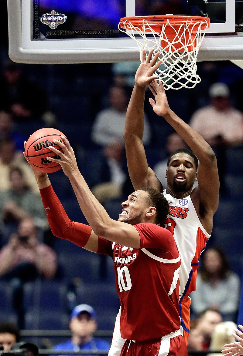 Arkansas forward Daniel Gafford (10) pulls in a rebound in front of Florida center Kevarrius Hayes (13) in the second half of an NCAA college basketball game at the Southeastern Conference tournament Thursday, March 14, 2019, in Nashville, Tenn. Florida won 66-50. (AP Photo/Mark Humphrey)