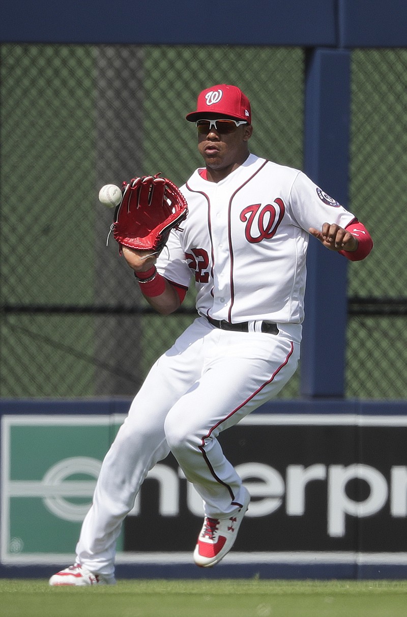 In this March 5, 2019, file photo, Washington Nationals outfielder Juan Soto (22) fields the ball in the fourth inning of an exhibition spring training baseball game against the Boston Red Sox in West Palm Beach, Fla. Soto, last season's surprise runner-up as NL Rookie of the Year at age 19, has a big hole to fill in the Nationals' lineup with Bryce Harper gone.  (AP Photo/Brynn Anderson, File)