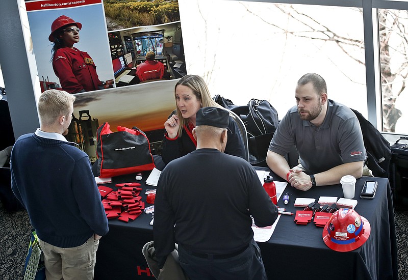 In this March 7, 2019, photo visitors to the Pittsburgh veterans job fair meet with recruiters at Heinz Field in Pittsburgh. On Friday, March 15, the Labor Department reports on job openings and labor turnover for January. (AP Photo/Keith Srakocic)
