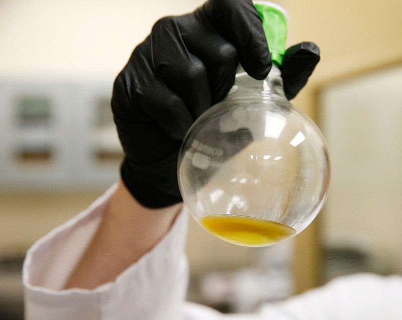 Chris Woods, director of processing at Xabis, holds up the distillate at Compassionate Cultivation in Manchaca, Texas, on February 7, 2018. (Vernon Bryant/Dallas Morning News/TNS)