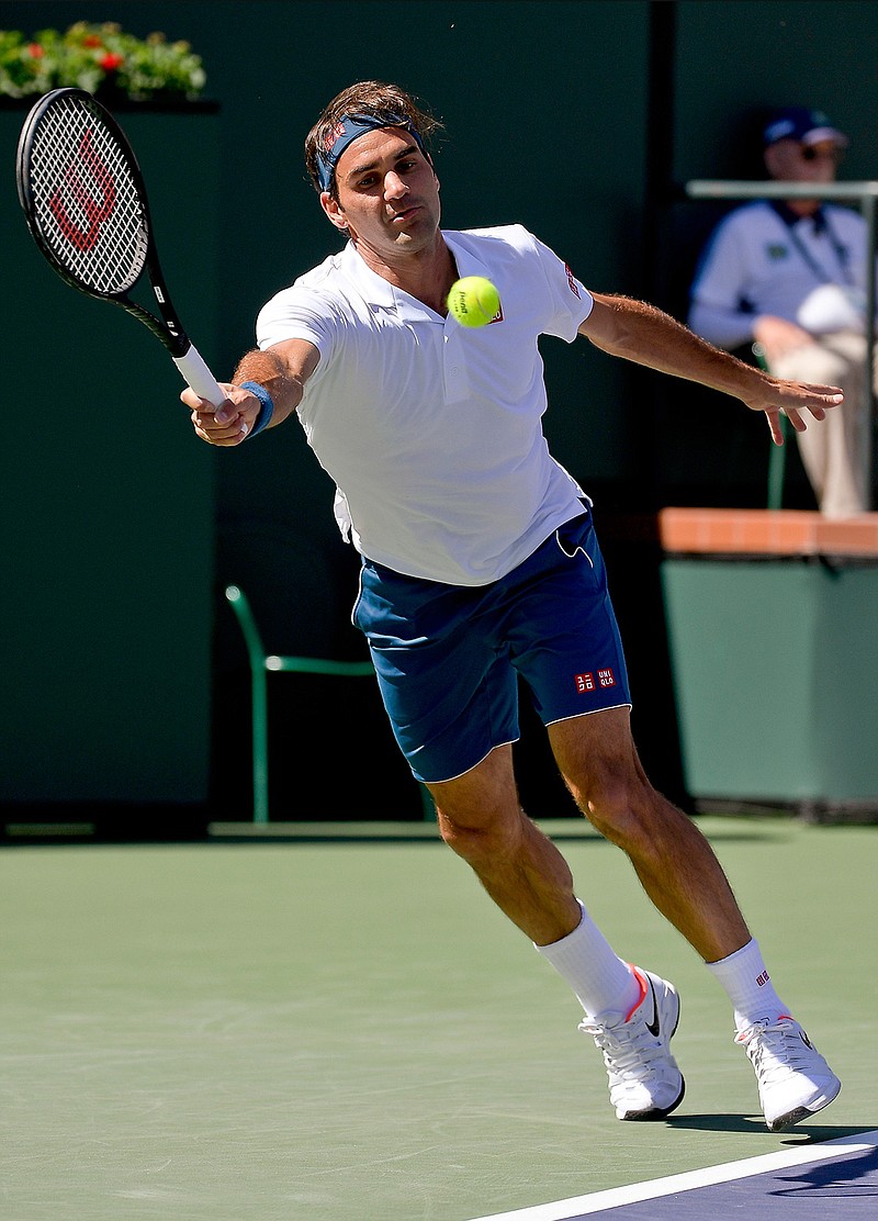 Roger Federer, of Switzerland, returns a shot to Hubert Hurkacz, of Poland, at the BNP Paribas Open tennis tournament Friday, March 15, 2019, in Indian Wells, Calif. (AP Photo/Mark J. Terrill)