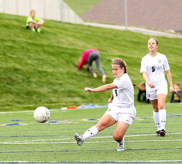 Krystal Brauner of Helias passes the ball downfield as teammate Lainy Lamb looks on during a game last season at the Crusader Athletic Complex.