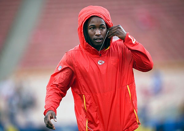 In this Nov. 19, 2018, file photo, Chiefs running back Kareem Hunt warms up before a game against the Rams in Los Angeles. The NFL has suspended Hunt for eight games after a video showed him kicking a woman and he was later involved in a fight at a resort.