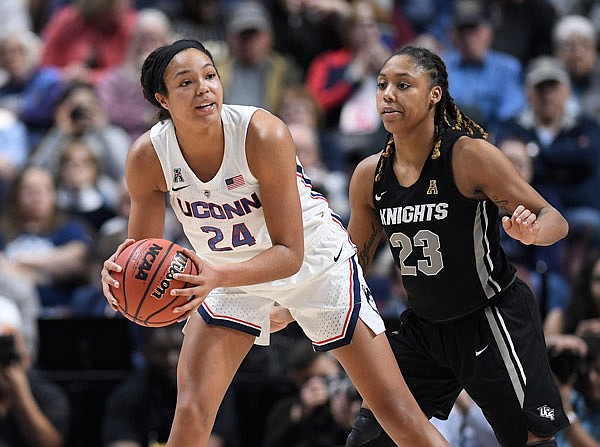Connecticut's Napheesa Collier is guarded by Central Florida's Lawriell Wilson during the second half of a game Monday in the American Athletic Conference Tournament finals at Mohegan Sun Arena in Uncasville, Conn.