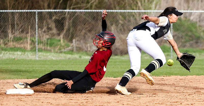 Liberty-Eylau's Keeley Norris slides into second base as a Pittsburg Pirate misses the ball Friday at H.E. Markham Park. The Lady Leopards won, 3-0.